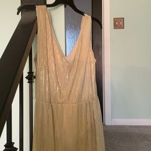 This is a gold dress. It is sleeveless and has the V in front and back.